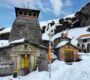 Chopta Tungnath in Spring Season with colorful entrance, surrounding shrines, and Himalayan mountain backdrop. Journeymitr